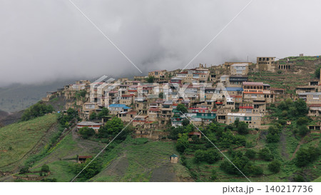 Mountain village of Chokh on green hillside under low clouds in Dagestan Mountain village of Chokh on green hillside under low clouds in Dagestan 140217736