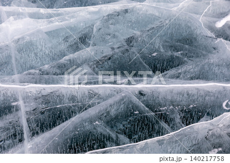 Winter ice texture with cracks and trapped bubbles on Lake Baikal surface, Russia 140217758