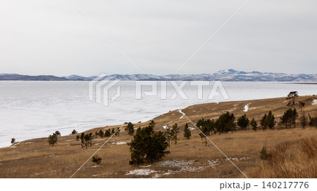 Winter shoreline with pine trees and frozen lake landscape near Olkhon Island Winter shoreline with pine trees and frozen lake landscape near Olkhon Island 140217776