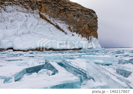 Winter ice hummocks and frozen cliff at Kharantsy Island on Lake Baikal Winter ice hummocks and frozen cliff at Kharantsy Island on Lake Baikal 140217807