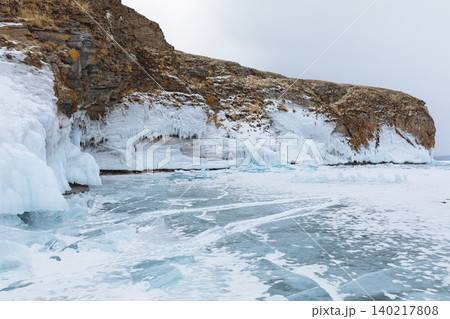 Winter ice cliffs and frozen shoreline on Kharantsy Island, Lake Baikal Winter ice cliffs and frozen shoreline on Kharantsy Island, Lake Baikal 140217808