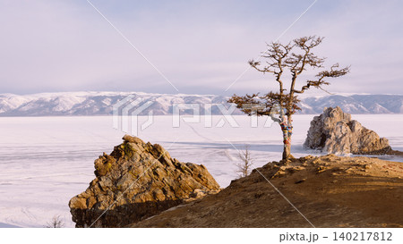 Shaman Rock on Olkhon Island with lone tree above frozen Lake Baikal Shaman Rock on Olkhon Island with lone tree above frozen Lake Baikal 140217812