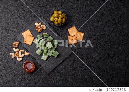 Hard green pesto cheese with herbs as a pasta ingredient. Green pesto cheese Hard green pesto cheese with herbs as a pasta ingredient. Green pesto cheese 140217868