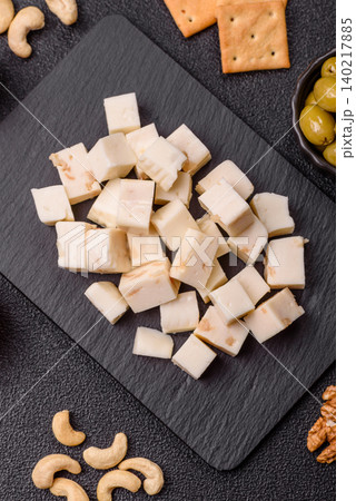 White feta, tofu, or mozzarella cheese cubes with herbs. White mozzarella cheese White feta, tofu, or mozzarella cheese cubes with herbs. White mozzarella cheese 140217885