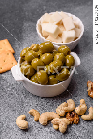 Whole green olives without pits in a bowl as an ingredient for cooking at home. Green olives Whole green olives without pits in a bowl as an ingredient for cooking at home. Green olives 140217906