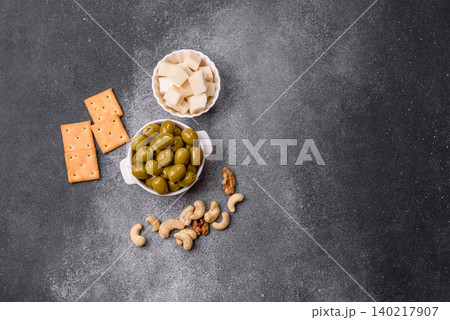 Whole green olives without pits in a bowl as an ingredient for cooking at home. Green olives Whole green olives without pits in a bowl as an ingredient for cooking at home. Green olives 140217907