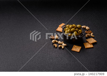 Whole green olives without pits in a bowl as an ingredient for cooking at home. Green olives Whole green olives without pits in a bowl as an ingredient for cooking at home. Green olives 140217909