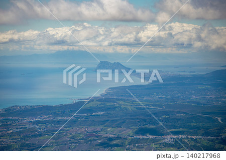 Sweeping mountain panorama revealing the sparkling Mediterranean Sea, Estepona and distant Gibraltar beneath open skies from Sierra Bermeja in Spain. Sweeping mountain panorama revealing the sparkling Mediterranean Sea, Estepona and distant Gibraltar beneath open skies from Sierra Bermeja in Spain. 140217968
