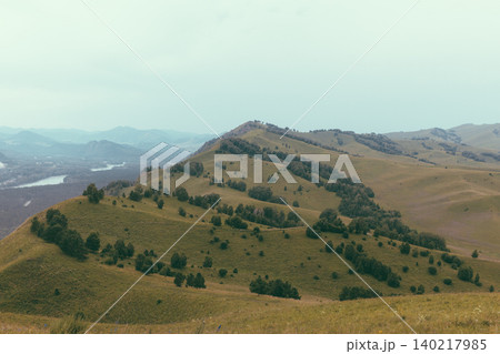 Devil's Finger Mountain ridge with rolling hills and forest, Altai landscape view Devil's Finger Mountain ridge with rolling hills and forest, Altai landscape view 140217985