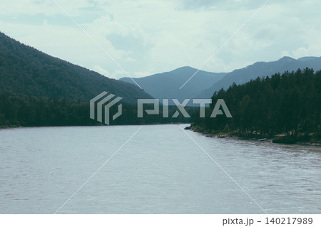 Misty mountain river valley landscape in Altai with forested slopes and clouds Misty mountain river valley landscape in Altai with forested slopes and clouds 140217989