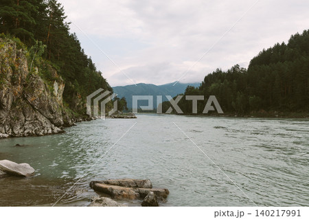 Mountain river valley landscape in Altai with pine forest and cloudy sky view Mountain river valley landscape in Altai with pine forest and cloudy sky view 140217991