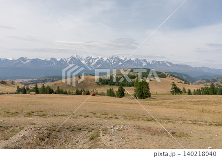 Wide panorama of Kurai Steppe with snowy Altai mountains under cloudy sky 140218040