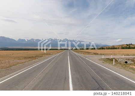 Open highway through Kurai Steppe toward snowcapped Altai Mountains, Russia 140218041