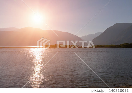 Sunset over Teletskoye Lake with mountain silhouettes and calm water, Altai Sunset over Teletskoye Lake with mountain silhouettes and calm water, Altai 140218051