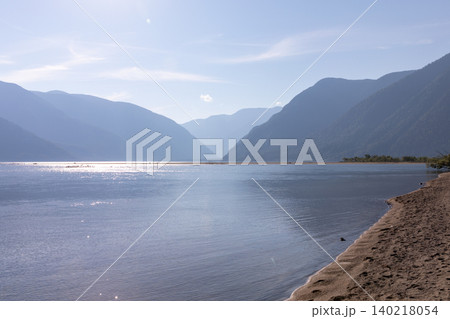 Scenic shoreline of Lake Teletskoye with mountain valley and calm water, Altai Scenic shoreline of Lake Teletskoye with mountain valley and calm water, Altai 140218054