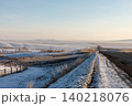 Winter road through Tazheran Steppe with snowy fields and wide horizon view 140218076