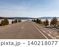 Empty asphalt highway through Tazheran Steppes with snowy fields and pines 140218077