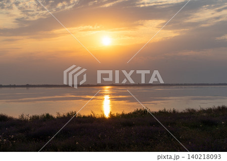 Golden sunset over the Tuzlivsky estuaries in Lebedivka, Ukraine, creating a peaceful and picturesque natural landscape. Golden sunset over the Tuzlivsky estuaries in Lebedivka, Ukraine, creating a peaceful and picturesque natural landscape. 140218093