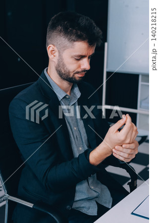 A man with a sore throat works inside the office, a businessman at work has a sore throat flu and cold, uses a laptop at work. A man with a sore throat works inside the office, a businessman at work has a sore throat flu and cold, uses a laptop at work. 140218215