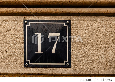 House Number 17 Sign on Stone Building Facade House Number 17 Sign on Stone Building Facade 140218263