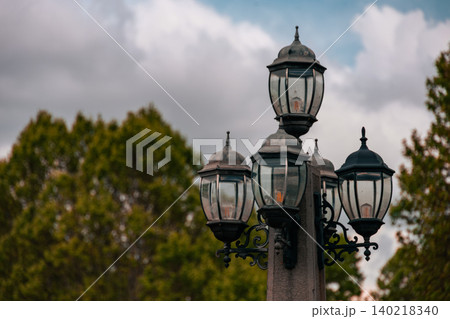 Vintage Ornate Street Lamp Against Dramatic Cloudy Sky, Decorative Urban Lighting Fixture Vintage Ornate Street Lamp Against Dramatic Cloudy Sky, Decorative Urban Lighting Fixture 140218340