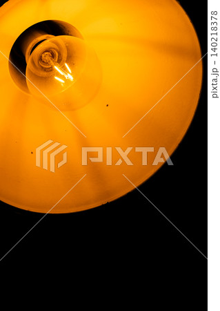 Warm Glowing Light Bulb Inside Vintage Industrial Metal Shade, Abstract Minimalist Lighting Warm Glowing Light Bulb Inside Vintage Industrial Metal Shade, Abstract Minimalist Lighting 140218378