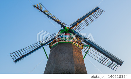 Close-up of traditional dutch windmill sails and wooden mechanism, detailed view of historic mill wheel wings against blue sky in zaanse schans netherlands 140218534