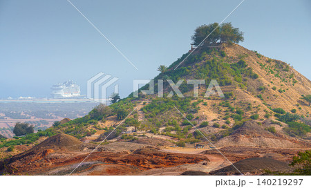 Sir Bani Yas Island, United Arab Emirates - Jan 18 2024, aerial panoramic view of tree-covered mountain, in background, the MSC Virtuosa cruise ship is moored near the beach, Sir Bani Yas Island, UAE Sir Bani Yas Island, United Arab Emirates - Jan 18 2024, aerial panoramic view of tree-covered mountain, in background, the MSC Virtuosa cruise ship is moored near the beach, Sir Bani Yas Island, UAE 140219297