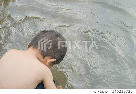 asian boy swimming in the sea asian boy swimming in the sea 140219726