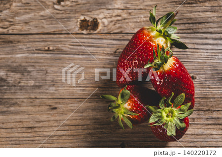 Red Strawberries Arranged on Old Wooden Texture.  140220172