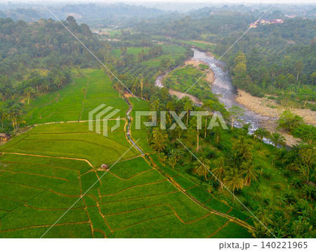 Beautiful morning view in Indonesia, panoramic landscape of rice fields with mountain ranges and clear sky Beautiful morning view in Indonesia, panoramic landscape of rice fields with mountain ranges and clear sky 140221965