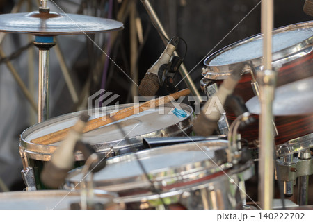 Closeup of drum set microphone drumsticks prepared for live music performance rehearsal recording entertainment events 140222702