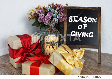 Season Of Giving message written on easel blackboard 140223609