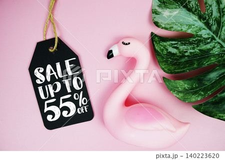 Price tag Sale 55% with summer decorations on pink background 140223620