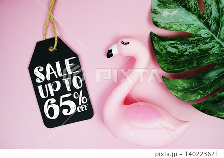 Price tag Sale 65% with summer decorations on pink background 140223621