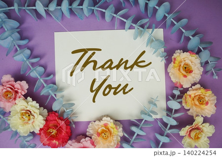Thank You text written on paper card with flowers decoration 140224254