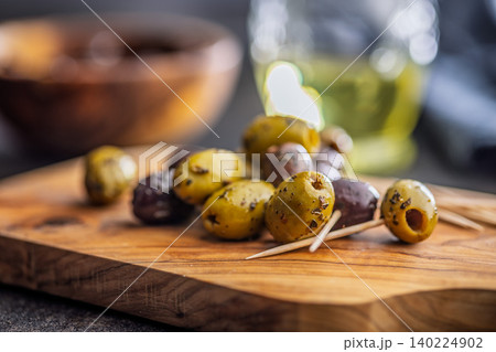 Marinated Olives On Wooden Board With Toothpicks And Olive Oil For Appetizer Platter 140224902