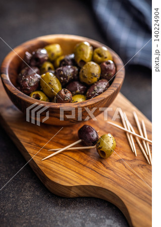 Marinated Olives On Wooden Board With Toothpicks And Olive Oil For Appetizer Platter 140224904