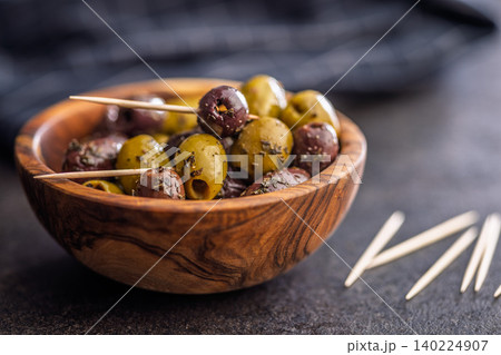 Marinated Mixed Olives in Wooden Bowl With Olive Oil and Toothpicks Mediterranean Appetizer Marinated Mixed Olives in Wooden Bowl With Olive Oil and Toothpicks Mediterranean Appetizer 140224907
