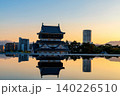 Kokura Castle with skyscraper reflection on pond at sunset, Kitakyushu 140226510