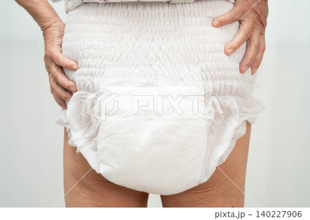 Asian senior woman patient wearing adult incontinence diaper pad in hospital. 140227906