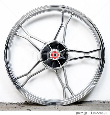 Silver motorcycle wheel rim cast alloy five spoke design with black hub and red bearing isolated on white background for motorbike repair and tuning Silver motorcycle wheel rim cast alloy five spoke design with black hub and red bearing isolated on white background for motorbike repair and tuning 140228620