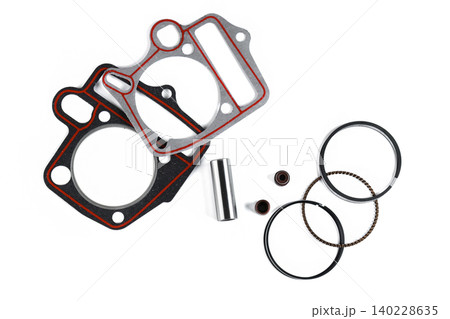 Motorcycle engine cylinder head gasket set with piston rings and pin top view. Motorcycle engine cylinder head gasket set with piston rings and pin top view. 140228635