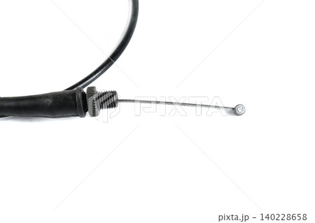 Motorcycle throttle cable steel inner wire with threaded barrel adjuster close up. Motorcycle throttle cable steel inner wire with threaded barrel adjuster close up. 140228658