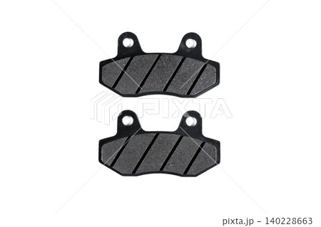 Motorcycle grooved disc brake pad set with steel backing plate isolated on white. Motorcycle grooved disc brake pad set with steel backing plate isolated on white. 140228663
