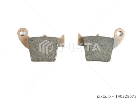 Motorcycle sintered disc brake pad set with copper backing plate isolated top view. Motorcycle sintered disc brake pad set with copper backing plate isolated top view. 140228675