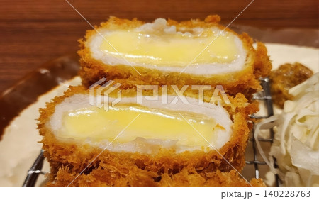 Golden Brown Crispy Fried Pork Cutlet filled with Gooey Melted Cheese Golden Brown Crispy Fried Pork Cutlet filled with Gooey Melted Cheese 140228763
