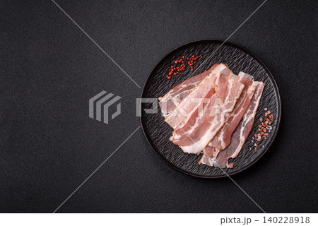 Raw fresh bacon slices with layers of meat or prosciutto with salt and spices. Raw bacon 140228918