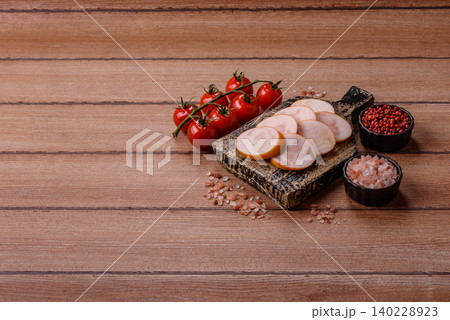 Slices of cooked chicken sausage for sandwiches and antipasto for dinner. Sausage slices 140228923