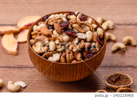 A mix of pistachios, hazelnuts, walnuts, peanuts, dried berries, and fruits. A mix of nuts A mix of pistachios, hazelnuts, walnuts, peanuts, dried berries, and fruits. A mix of nuts 140228968